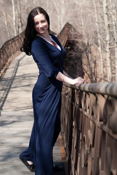 Model on the pedestrian bridge with metal railings — Stock Photo, Image