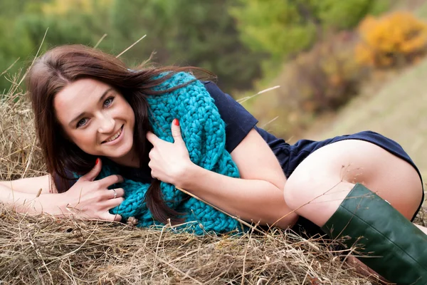 Beautiful girl lying in a haystack — Stock Photo, Image