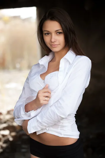 Girl in white shirt covers underwear — Stock Photo, Image
