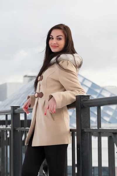 Beautiful young brunette in a coat — Stock Photo, Image