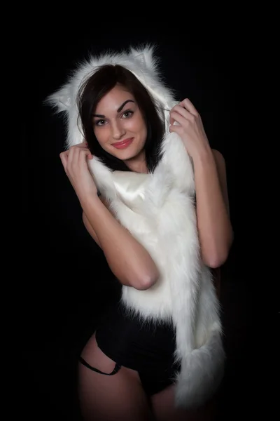 Portrait of a girl with a fur cape on a black background — Stock Photo, Image