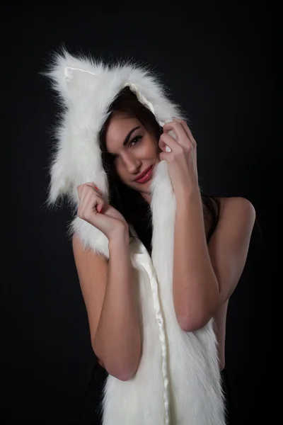 Portrait of a girl with a fur cape on a black background — Stock Photo, Image