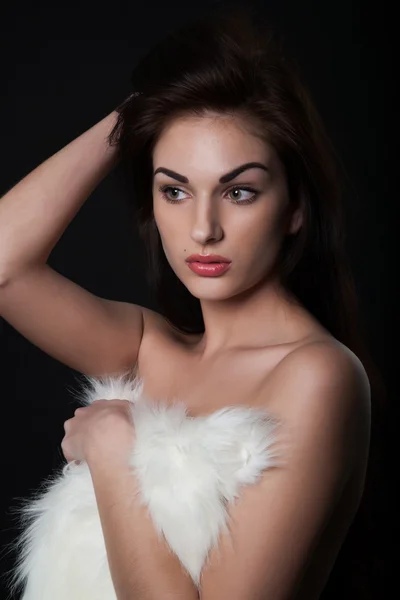Girl covers her bare chest fur cape — Stock Photo, Image