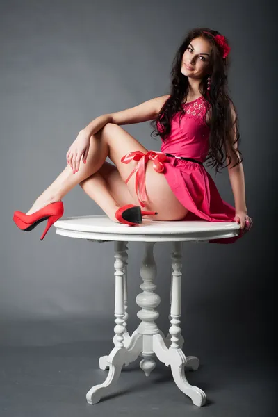 Girl sitting on the table — Stock Photo, Image