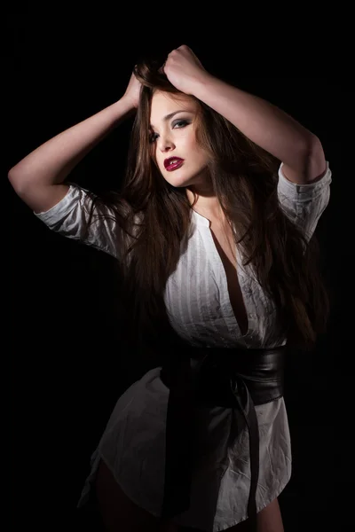 Portrait of a girl in a white shirt on a black background — Stock Photo, Image