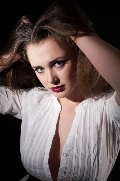 Portrait of a girl in a white shirt on a black background — Stock Photo, Image