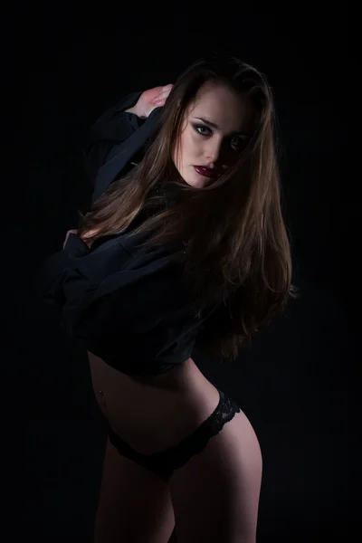 Studio portrait of a girl on a black background — Stock Photo, Image