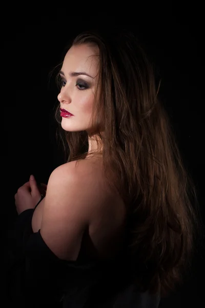 Studio portrait of a girl on a black background — Stock Photo, Image