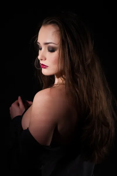 Studio portrait of a girl on a black background — Stock Photo, Image