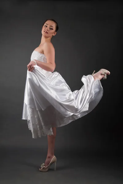 Bride in a white dress. Studio portrait on gray background — Stock Photo, Image