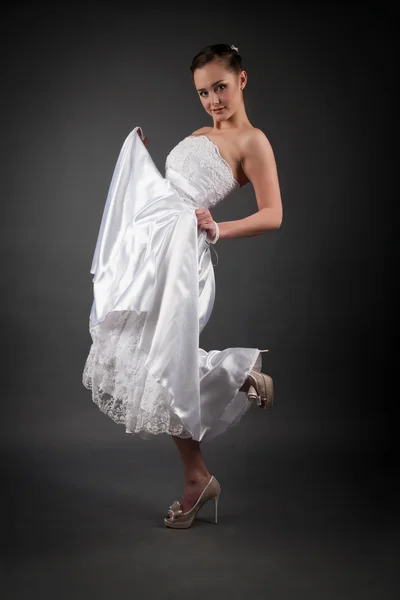 Bride in a white dress. Studio portrait on gray background — Stock Photo, Image