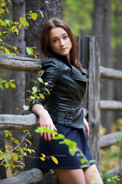 Kız sonbahar ormandaki deri ceket