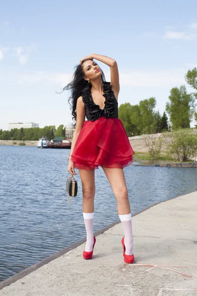 Sexy young girl on the river embankment — Stock Photo, Image