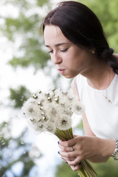 Girl with a bouquet of dandelions — Stock Photo, Image