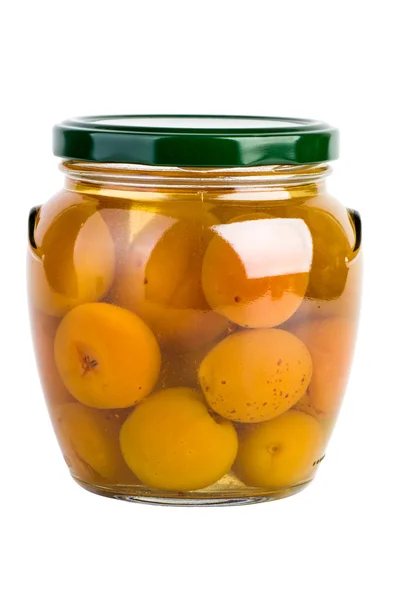 Glass jar with preserved apricots — Stock Photo, Image