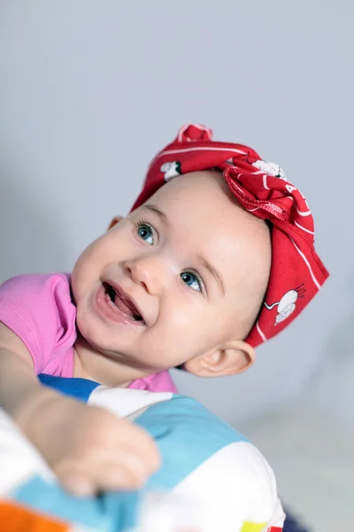 Baby hiding behind a pillow — Stock Photo, Image