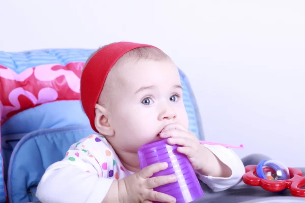 Baby with cup and spoon — Stock Photo, Image