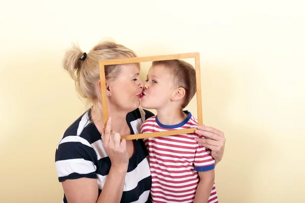 Pregnant woman kisses her son — Stock Photo, Image