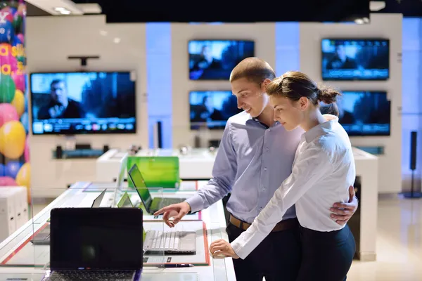 Pareja joven en tienda de electrónica de consumo — Foto de Stock