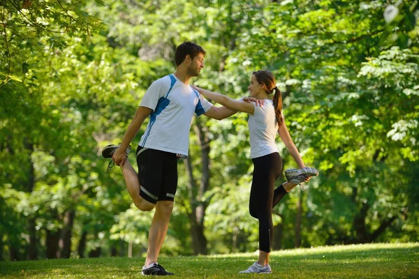 Couple doing stretching exercise after jogging Stock Image