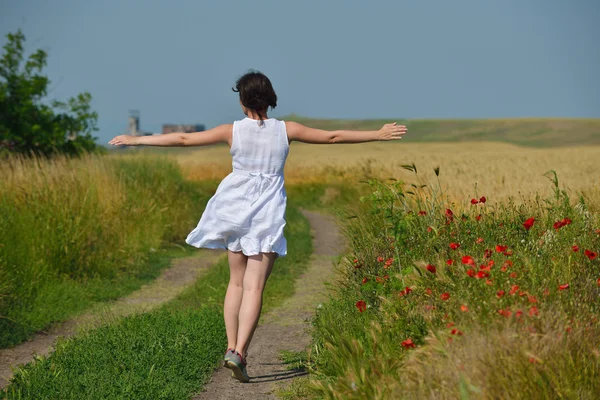 Mujer joven en el campo de trigo en verano — Foto de Stock