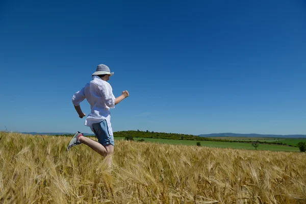 Young woman in wheat field at summer — Stock Photo, Image