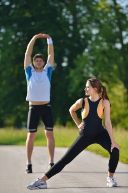 Çift koşudan sonra esneme egzersizi yapıyor.