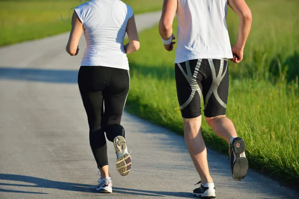 Unga par joggar på morgonen — Stockfoto