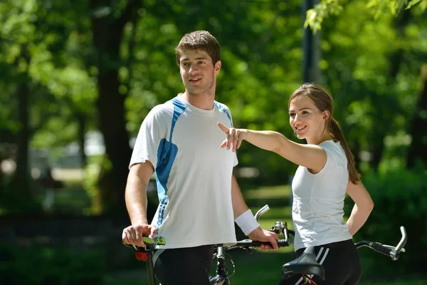 Happy couple riding bicycle outdoors — Stock Photo, Image