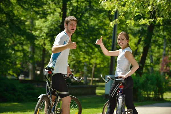 Happy couple riding bicycle outdoors — Stock Photo, Image