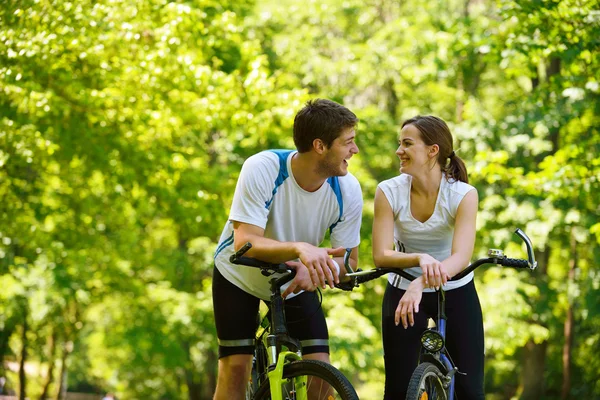 Happy couple riding bicycle outdoors — Stock Photo, Image