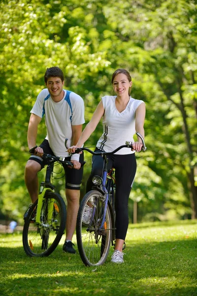 Happy couple riding bicycle outdoors — Stock Photo, Image