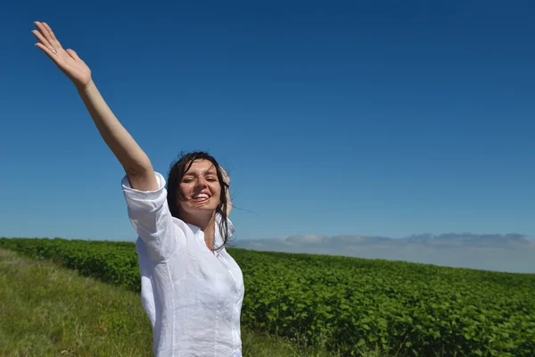 Young happy woman in green field — Stock Photo, Image