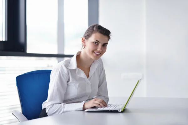 Young pretty business woman with notebook in the office — Stock Photo, Image