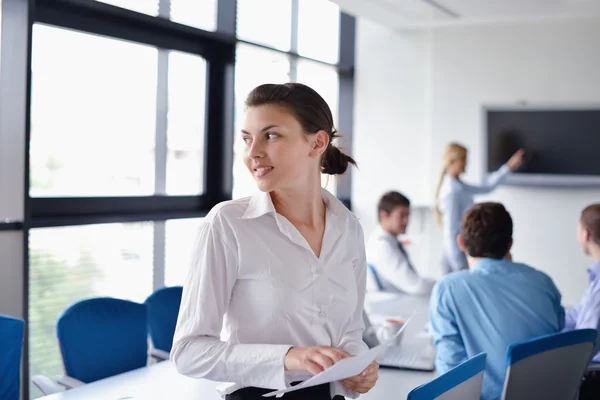 Femme d'affaires avec son personnel en arrière-plan au bureau — Photo