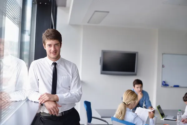 Business man on a meeting in offce with colleagues in backgroun — Stock Photo, Image