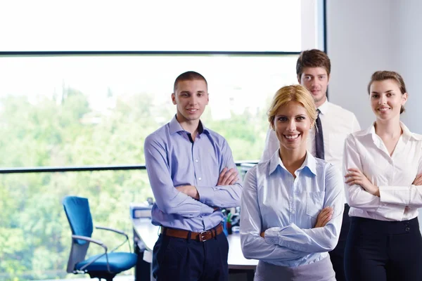 Business woman with her staff in background at office — Stock Photo, Image