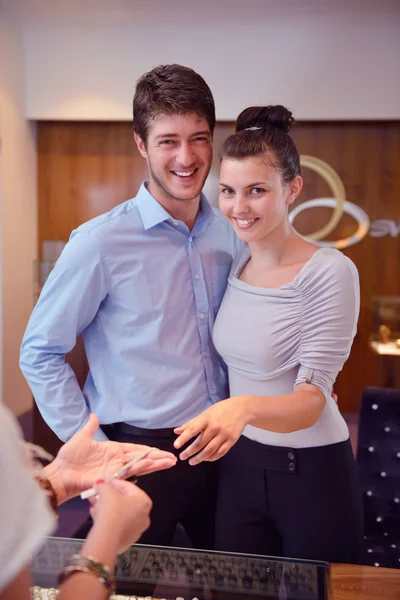 Happy young couple in jewelry store Stock Image