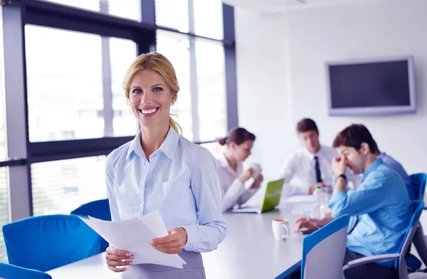 Femme d'affaires avec son personnel en arrière-plan au bureau — Photo