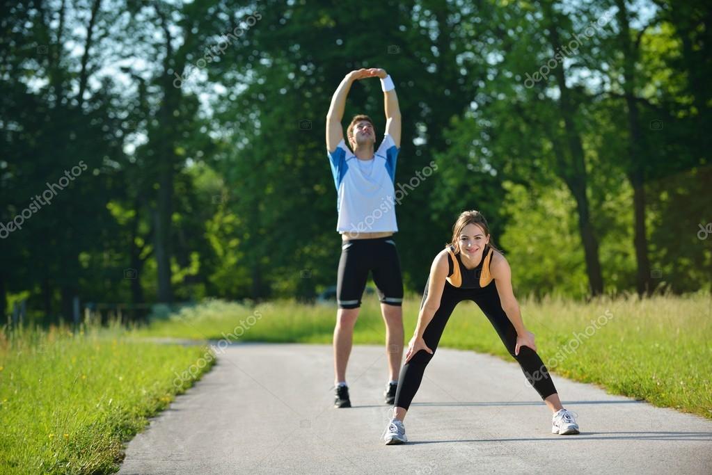 Doing stretching exercise after jogging — Stock Photo © .shock 16790167