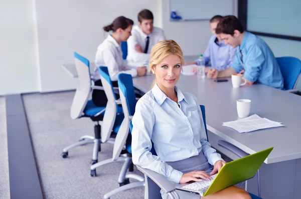 Zakenvrouw met haar personeel op achtergrond op kantoor — Stockfoto