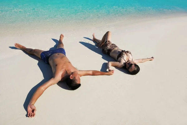 Feliz jovem casal desfrutando de verão na praia — Fotografia de Stock