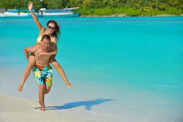 Feliz jovem casal desfrutando de verão na praia — Fotografia de Stock