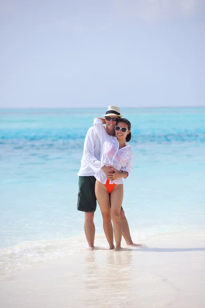 Glückliches junges Paar hat Spaß am Strand — Stockfoto