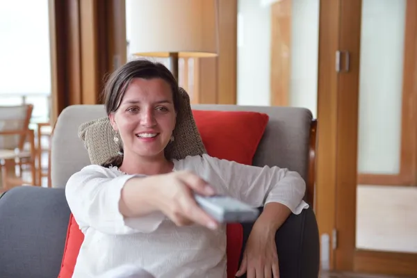 Happy young woman relax at home on sofa — Stock Photo, Image