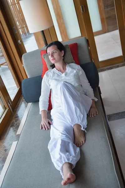 Heureuse jeune femme se détendre à la maison sur le canapé — Photo