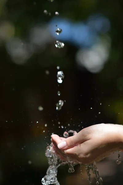Corriente de agua en la mano mujer — Foto de Stock