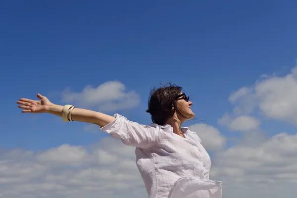 Young woman with spreading arms to sky — Stock Photo, Image