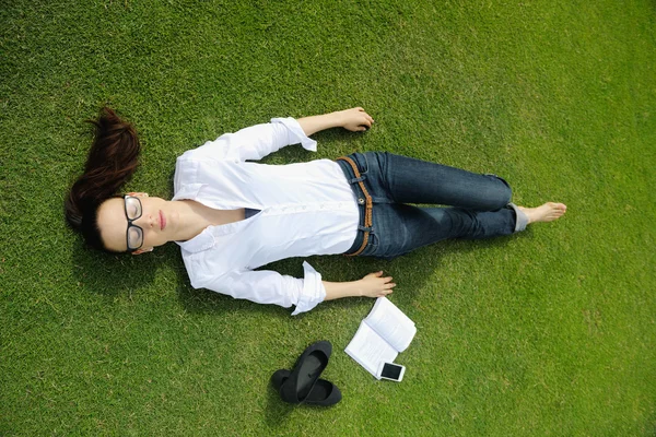 Junge Frau liest im Park ein Buch — Stockfoto