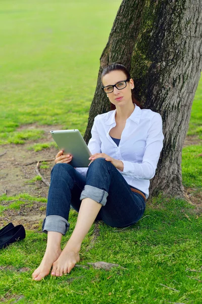 Belle jeune femme avec tablette dans le parc — Photo